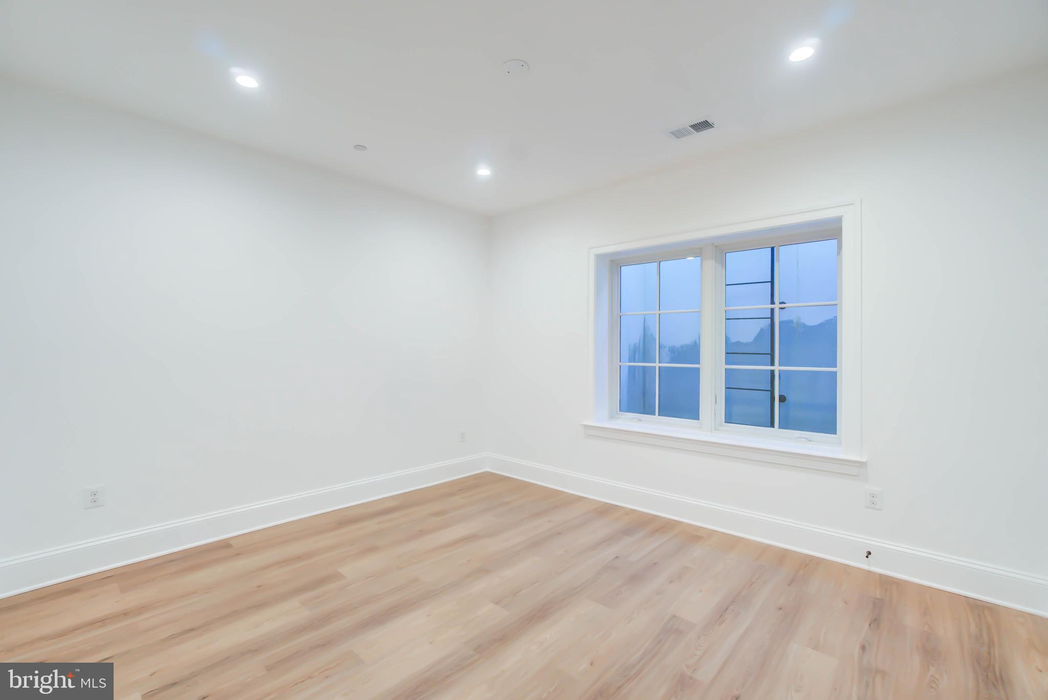 4422 Walsh Street Chevy Chase, MD 20815 - Photo 78 of 93 an empty room with wooden floor and windows