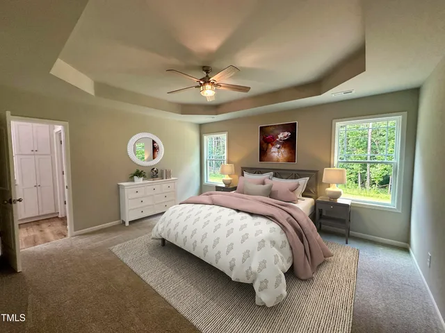 a bedroom with a large bed and a chandelier