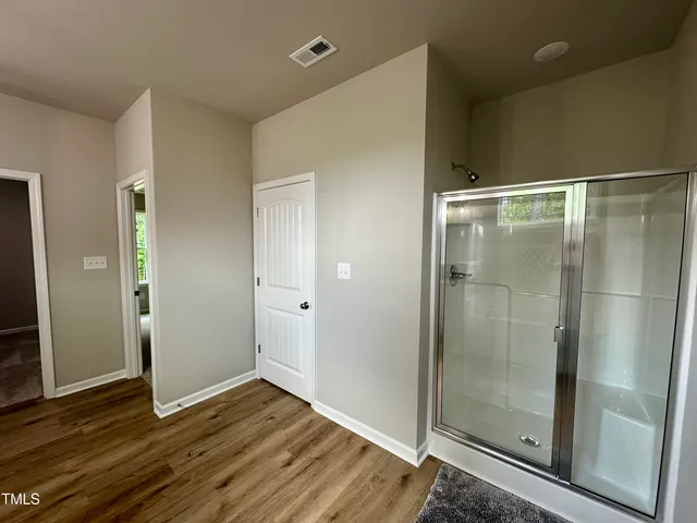 a view of a bathroom with wooden floor