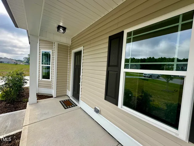 a view of a balcony with floor to ceiling window and wooden floor