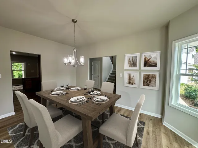 a view of a dining room with furniture wooden floor and chandelier