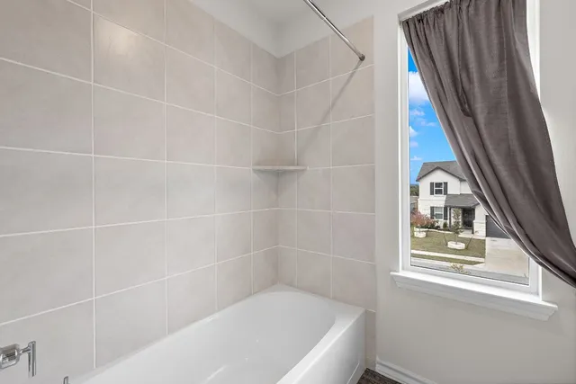 a bath tub sitting next to a window