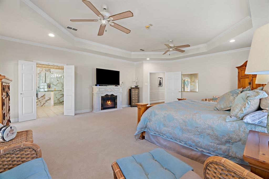 72 Crown Road Willow Park, TX 76087 - Photo 20 of 40 a spacious bedroom with a bed and a flat screen tv