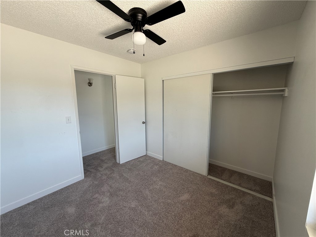 14538 Springvale Street Poway, CA 92064 - Photo 25 of 47 an empty room with ceiling fan and window