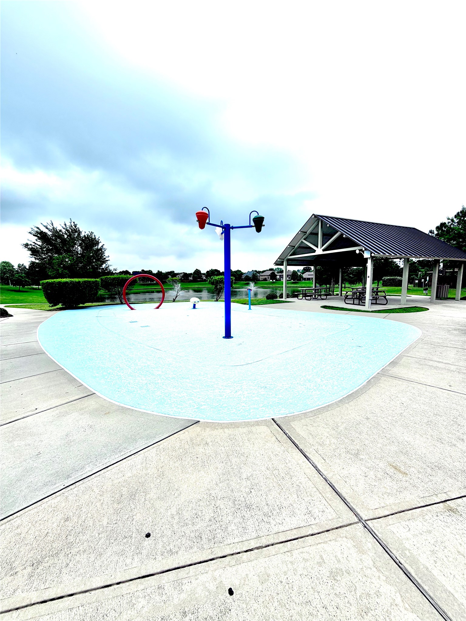 7046 Sliding Rock Circle Spring, TX 77379 - Photo 40 of 41 This inviting splash pad offers a perfect spot for family fun and relaxation, complete with nearby seating and a picturesque park setting. Ideal for creating lasting memories!