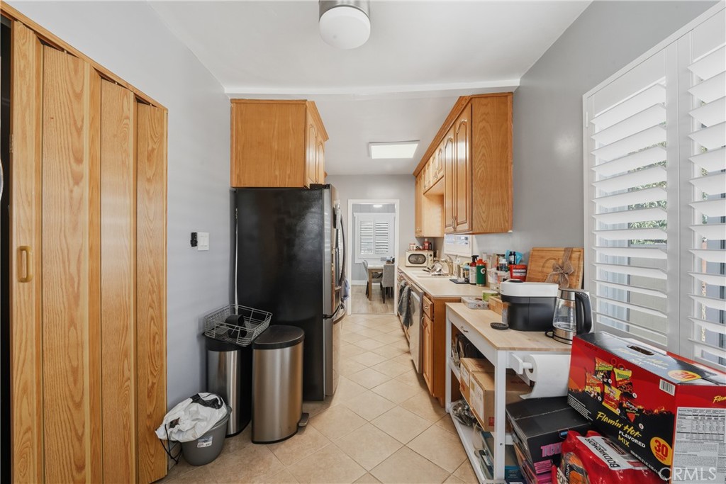 11340 Virginia Street Lynwood, CA 90262 - Photo 16 of 53 a kitchen with a refrigerator and a sink