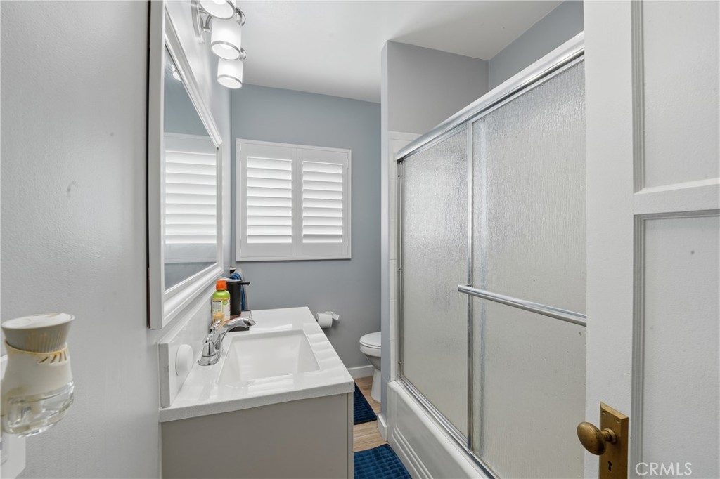11340 Virginia Street Lynwood, CA 90262 - Photo 19 of 53 a bathroom with a sink a toilet and a mirror