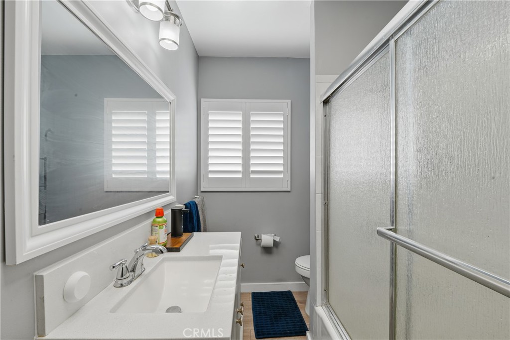 11340 Virginia Street Lynwood, CA 90262 - Photo 21 of 53 a bathroom with a sink a toilet and a window