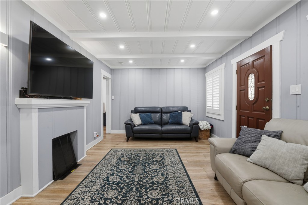 11340 Virginia Street Lynwood, CA 90262 - Photo 5 of 53 a living room with furniture a flat screen tv and a fireplace