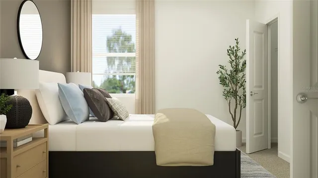 a bedroom with a bed and a potted plant