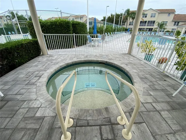 a view of a swimming pool with outdoor seating