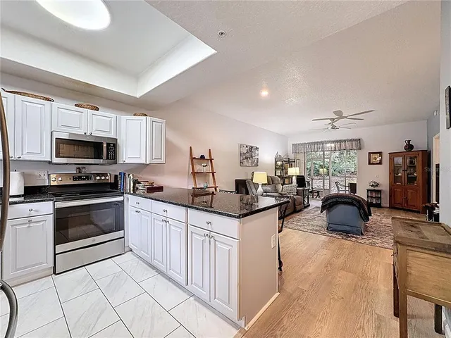a kitchen with granite countertop a sink and appliances