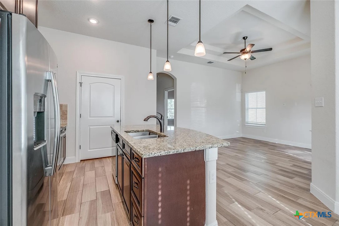 3133 Puter Creek Road, Unit B Spring Branch, TX 78070 - Photo 9 of 19 a kitchen with stainless steel appliances granite countertop cabinets a sink and a refrigerator