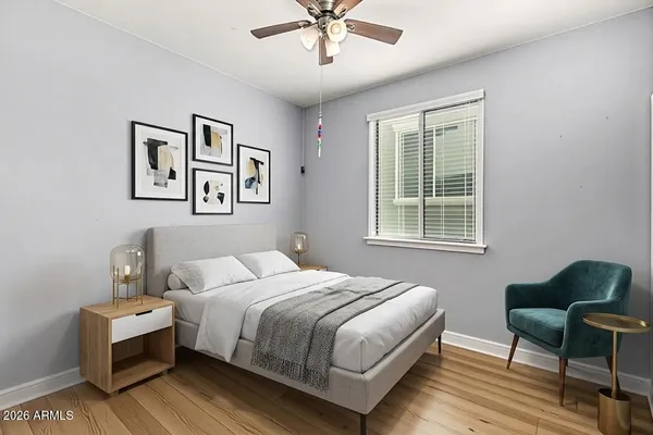 a bedroom with a bed and a chair with the potted plant