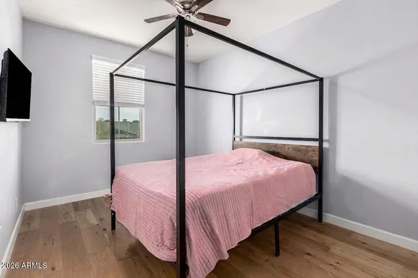 a bedroom with a bed and a flat screen tv