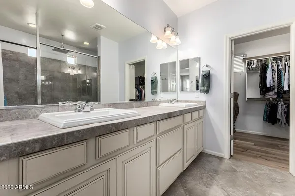 a bathroom with double vanity sink and a mirror