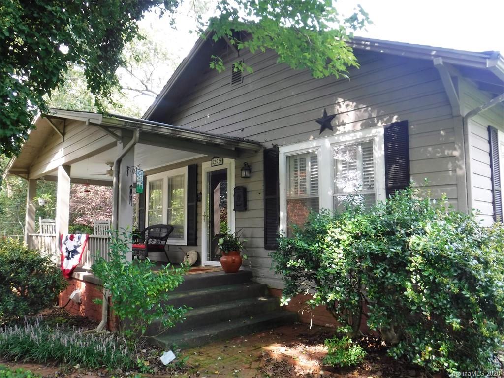 a view of a house with brick walls and potted plants