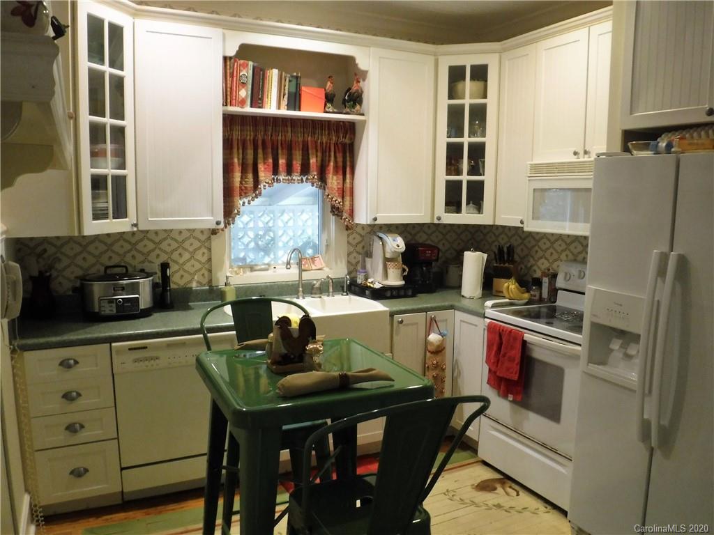 206 Callahan Street Rutherfordton, NC 28139 - Photo 11 of 48 a kitchen with a refrigerator and a stove top oven