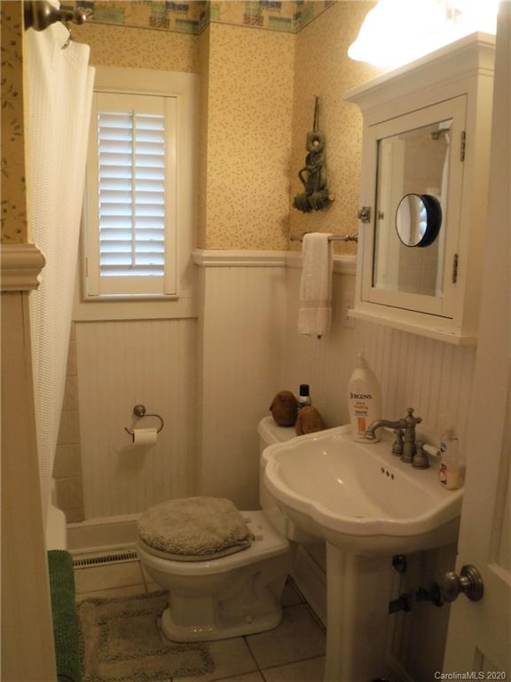 206 Callahan Street Rutherfordton, NC 28139 - Photo 26 of 48 a bathroom with a sink a toilet and mirror