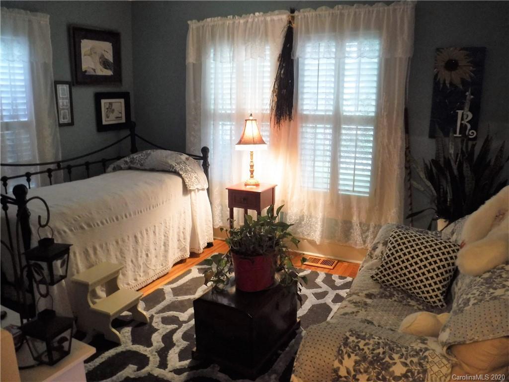 206 Callahan Street Rutherfordton, NC 28139 - Photo 30 of 48 a bedroom with a bed and wooden floor