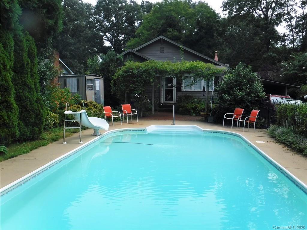 206 Callahan Street Rutherfordton, NC 28139 - Photo 45 of 48 a view of a backyard with table and chairs under an umbrella