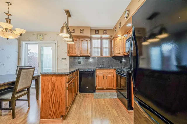 a kitchen with stainless steel appliances granite countertop a sink and cabinets