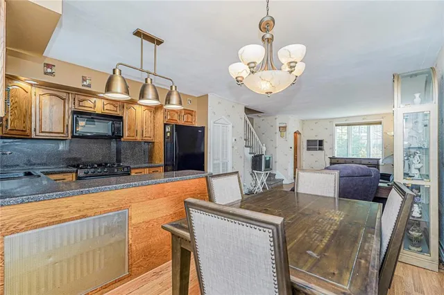 a kitchen with stainless steel appliances granite countertop a sink a stove and a refrigerator