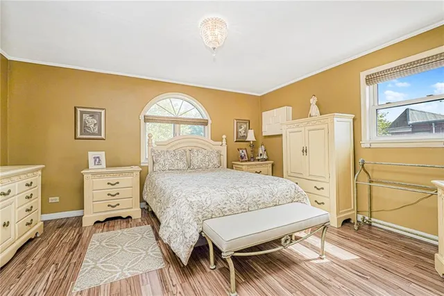 a spacious bedroom with a bed and a dresser