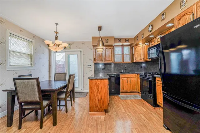 a dining room with a table chairs and entryway