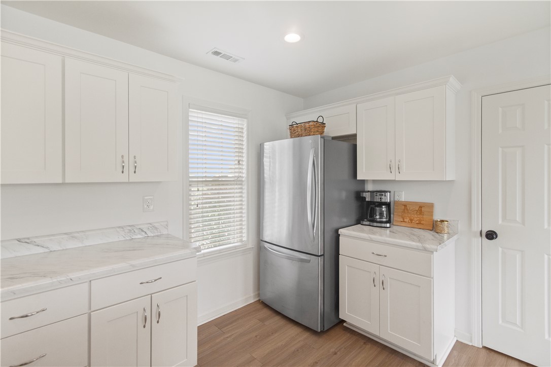 2900 Highway 187 Anderson, SC 29626 - Photo 13 of 41 White cabinetry with marble-inspired counters defines this sleek, modern kitchen space.