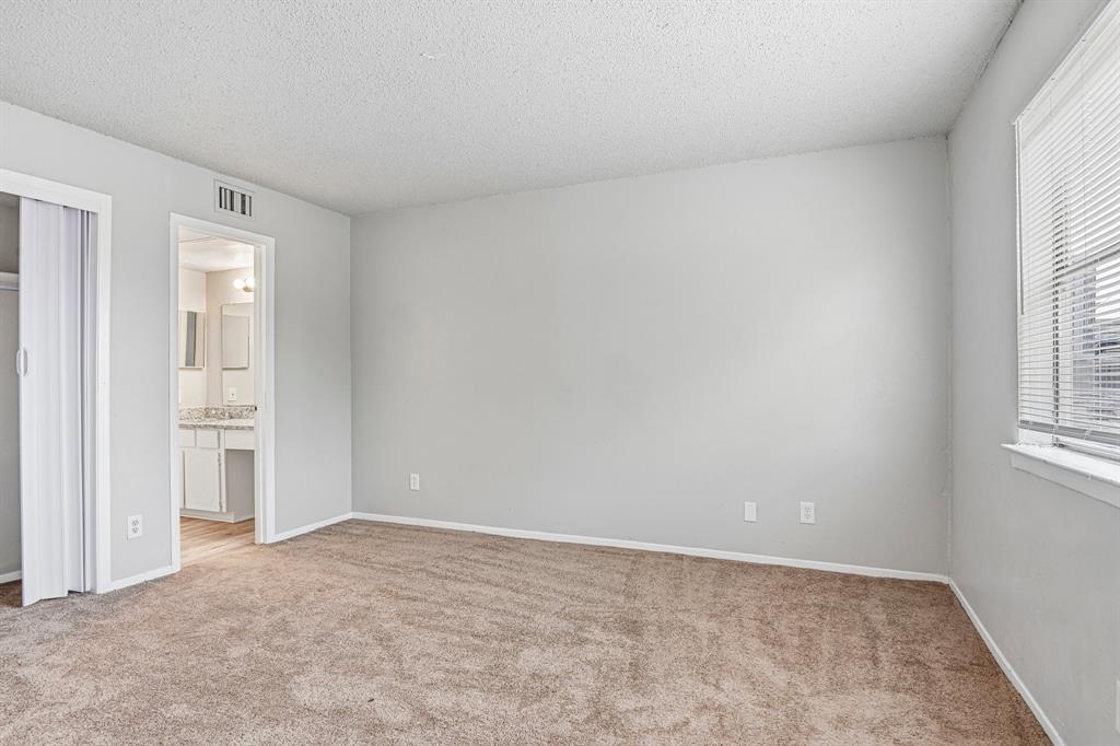 5534 Boca Raton Boulevard, Unit 292 Fort Worth, TX 76112 - Photo 28 of 31 an empty room with windows and closet