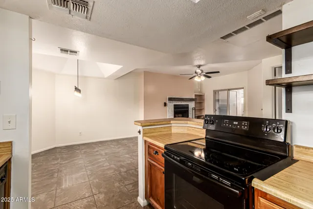 a black and white kitchen with a stove and a refrigerator