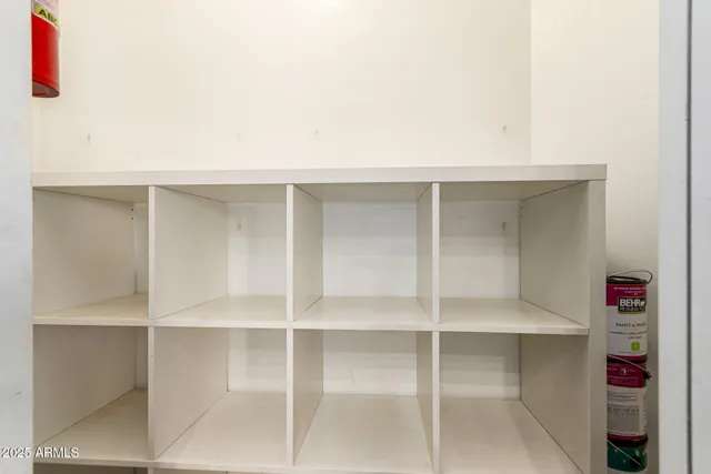 an empty room with a ceiling fan and a window