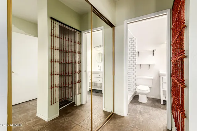 a bathroom with a toilet sink vanity and mirror