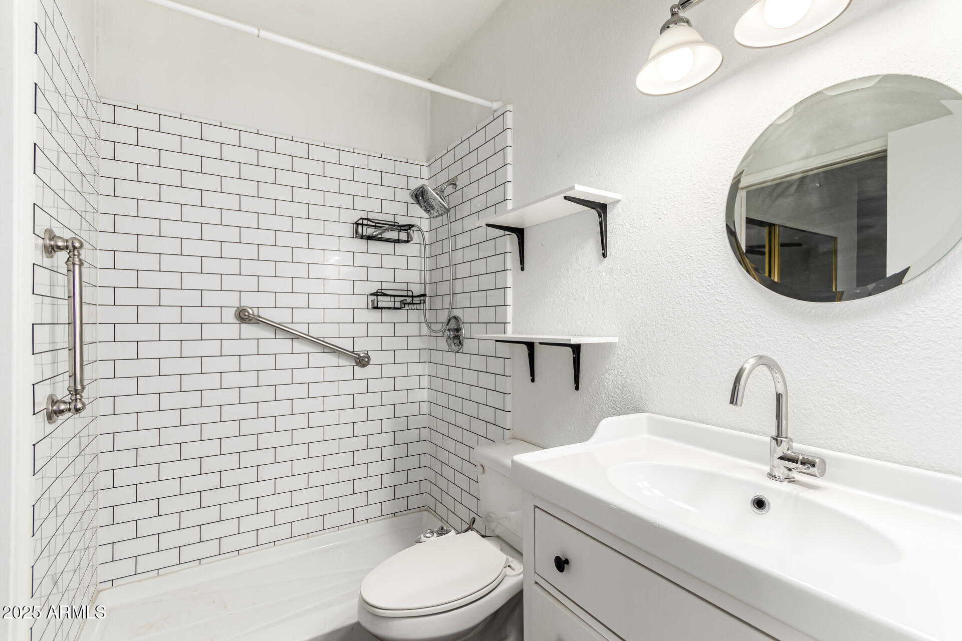 1352 East Highland Avenue, Unit 117 Phoenix, AZ 85014 - Photo 21 of 25 a bathroom with a toilet sink vanity and mirror