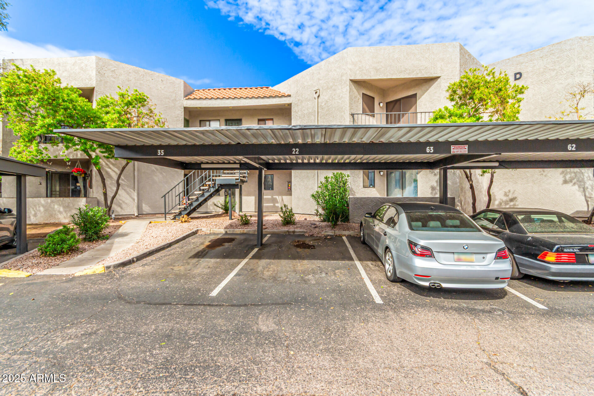 1352 East Highland Avenue, Unit 117 Phoenix, AZ 85014 - Photo 25 of 25 a car parked in front of a building