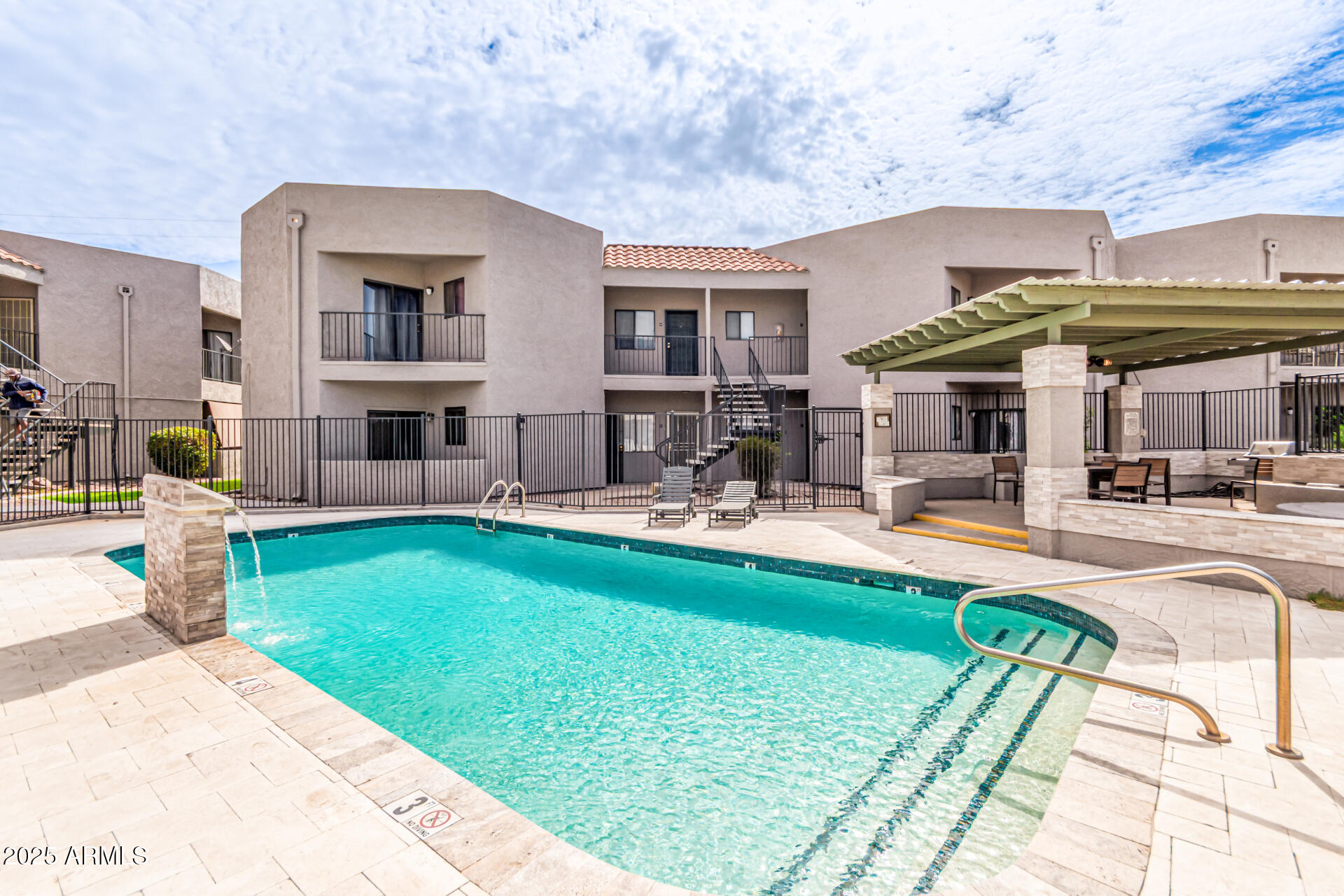 1352 East Highland Avenue, Unit 117 Phoenix, AZ 85014 - Photo 3 of 25 a front view of a house with swimming pool garden and patio