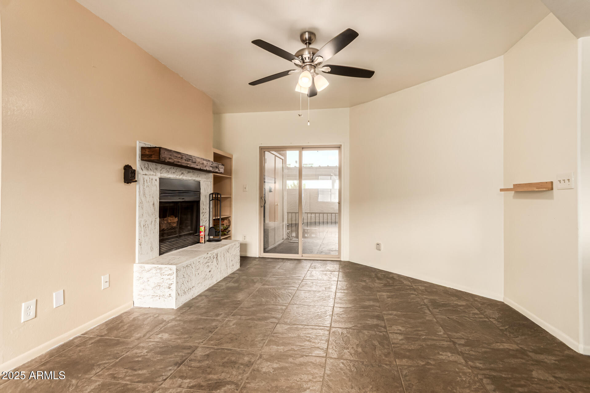 1352 East Highland Avenue, Unit 117 Phoenix, AZ 85014 - Photo 8 of 25 a view of an empty room with a fireplace