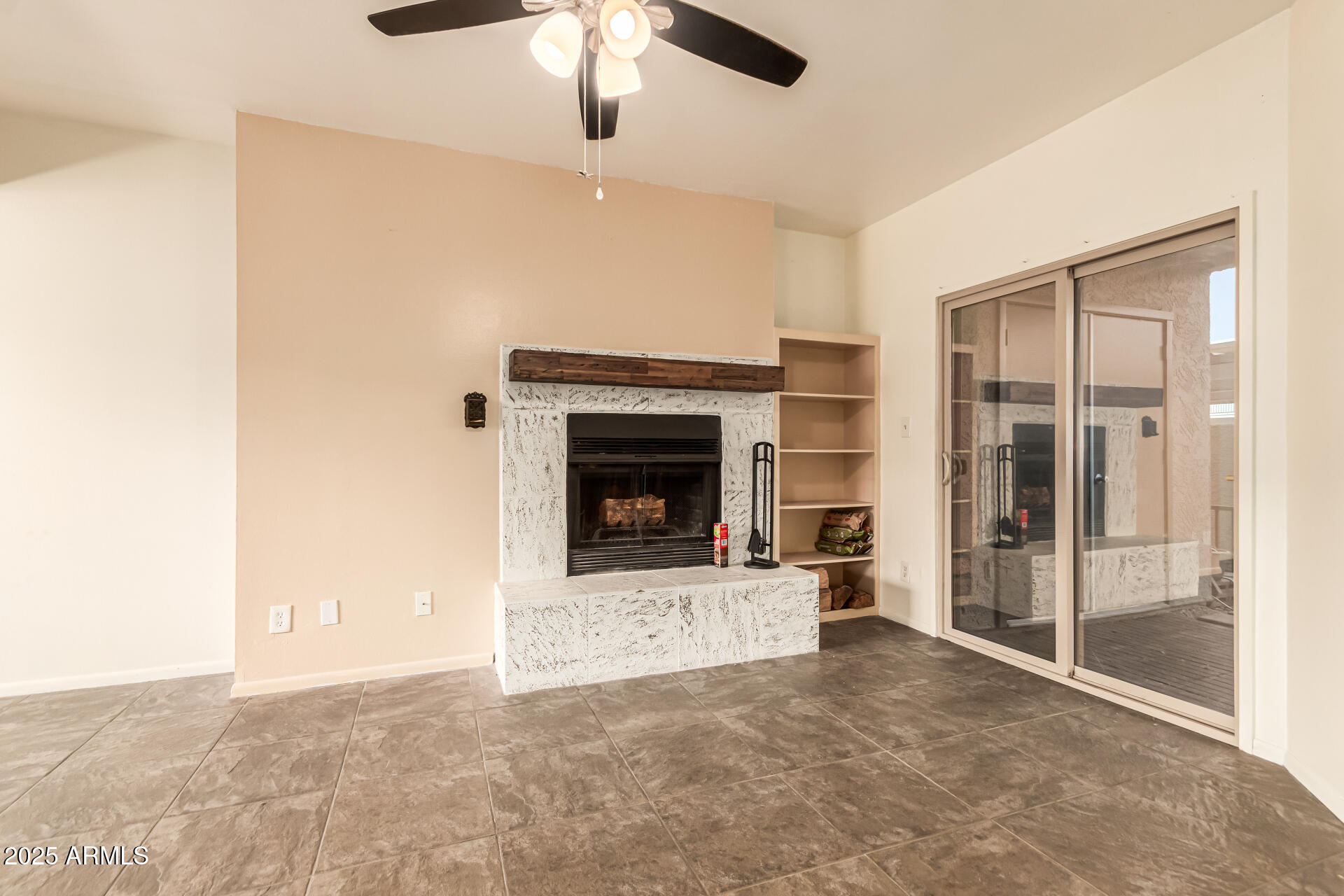1352 East Highland Avenue, Unit 117 Phoenix, AZ 85014 - Photo 9 of 25 a view of an empty room with a fireplace and a window