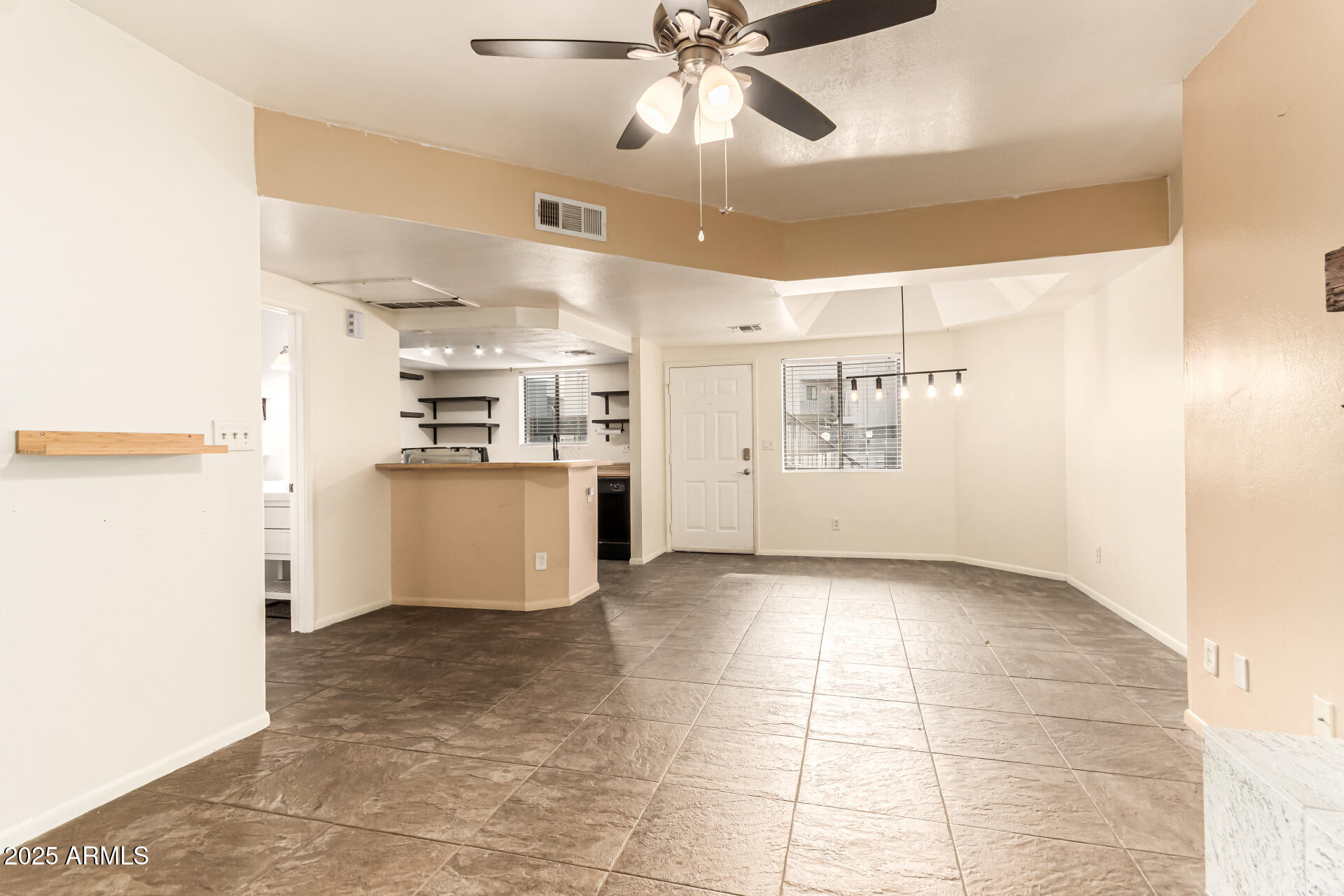 1352 East Highland Avenue, Unit 117 Phoenix, AZ 85014 - Photo 10 of 25 a view of a kitchen with a sink and a refrigerator