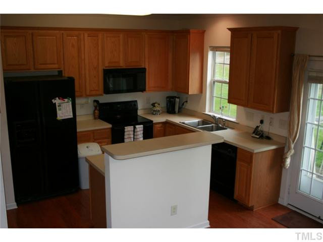 310 Burrell Road Durham, NC 27703 - Photo 3 of 21 Recently replaced garbage disposal. Kitchen includes overhead light as well as light over sink, several tall, all wood cabinets for great storage, pantry within the kitchen, kitchen island. Kitchen