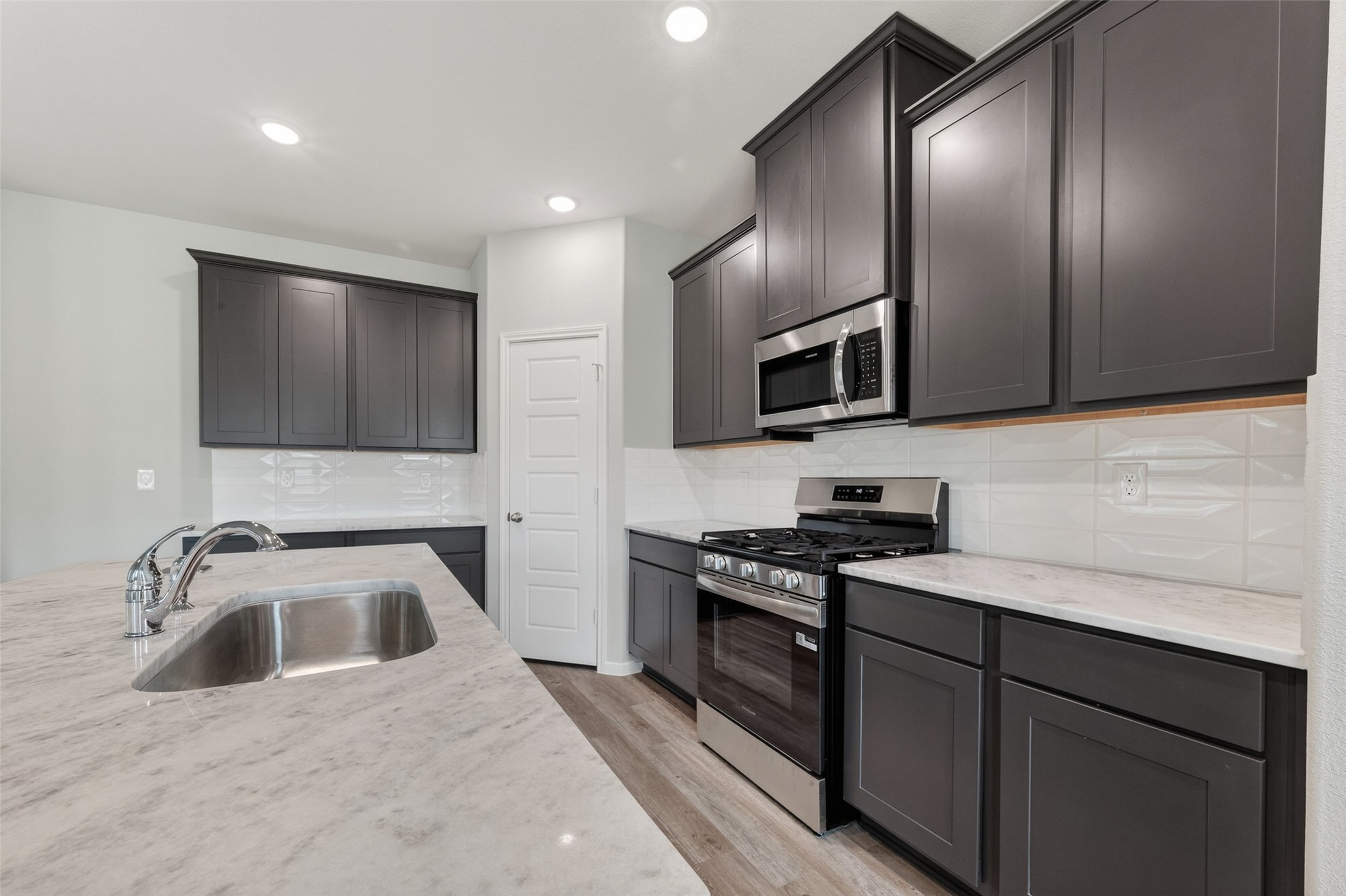 2107 Spring Hollow Drive Baytown, TX 77521 - Photo 11 of 42 a kitchen that has a sink and a stove top oven