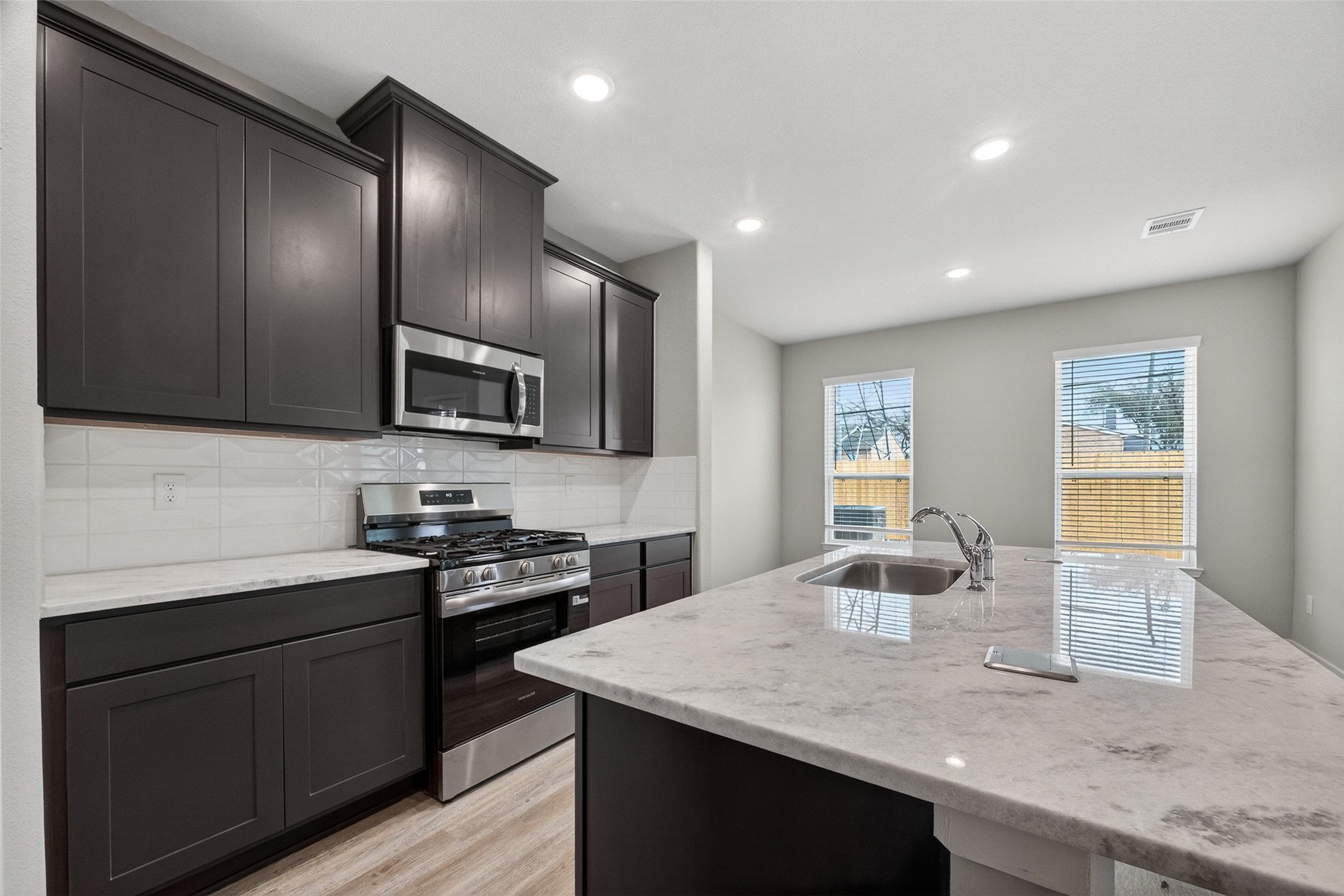 2107 Spring Hollow Drive Baytown, TX 77521 - Photo 13 of 42 a kitchen with a sink stove and microwave
