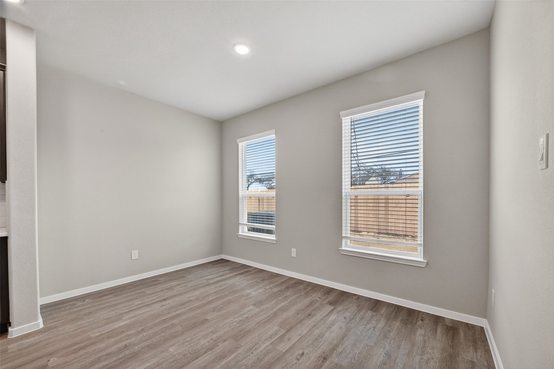 2107 Spring Hollow Drive Baytown, TX 77521 - Photo 16 of 42 an empty room with wooden floor and windows