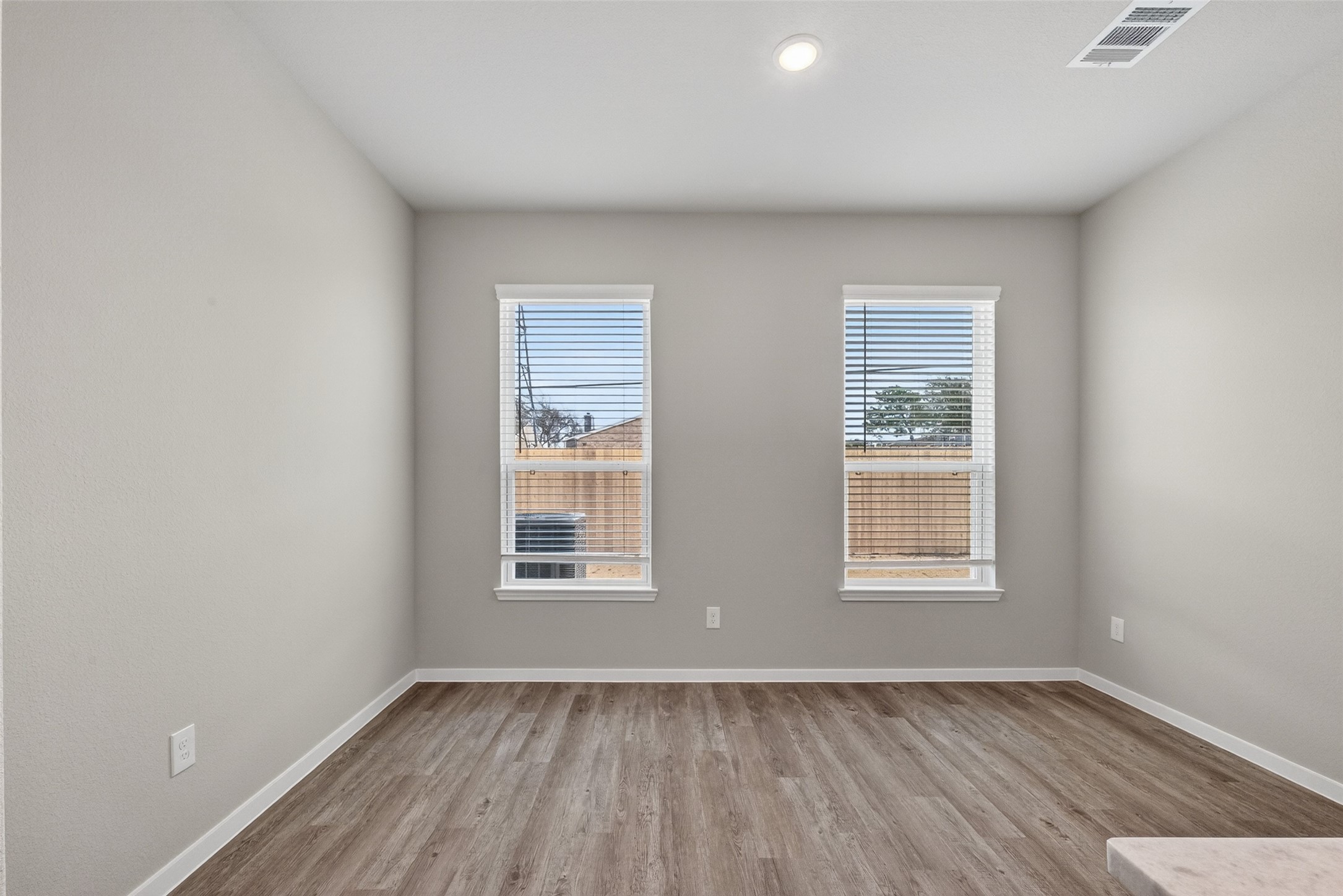 2107 Spring Hollow Drive Baytown, TX 77521 - Photo 17 of 42 an empty room with wooden floor and windows