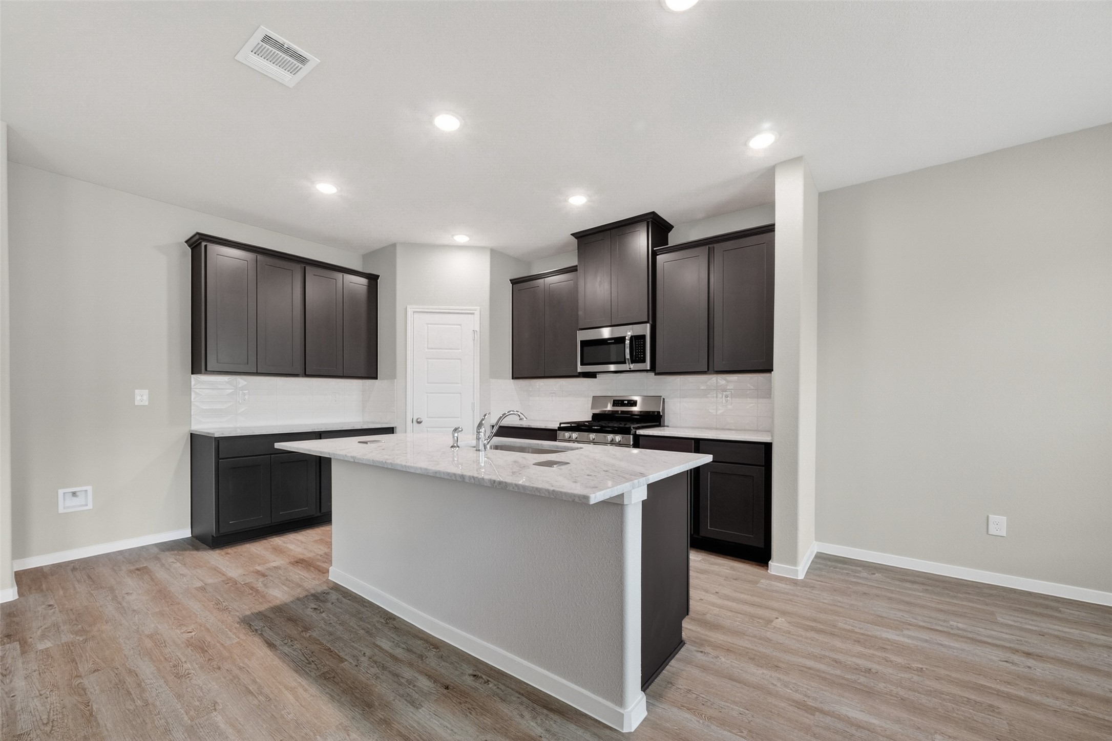 2107 Spring Hollow Drive Baytown, TX 77521 - Photo 10 of 42 a kitchen with stainless steel appliances a sink stove and refrigerator