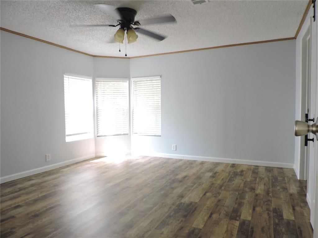 294 Tiger Lake Road Lake Wales, FL 33898 - Photo 23 of 56 a view of empty room with wooden floor and fan