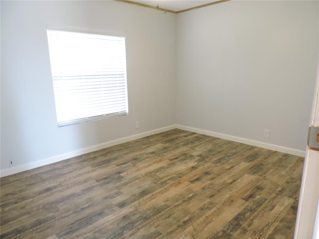 294 Tiger Lake Road Lake Wales, FL 33898 - Photo 38 of 56 an empty room with wooden floor and windows