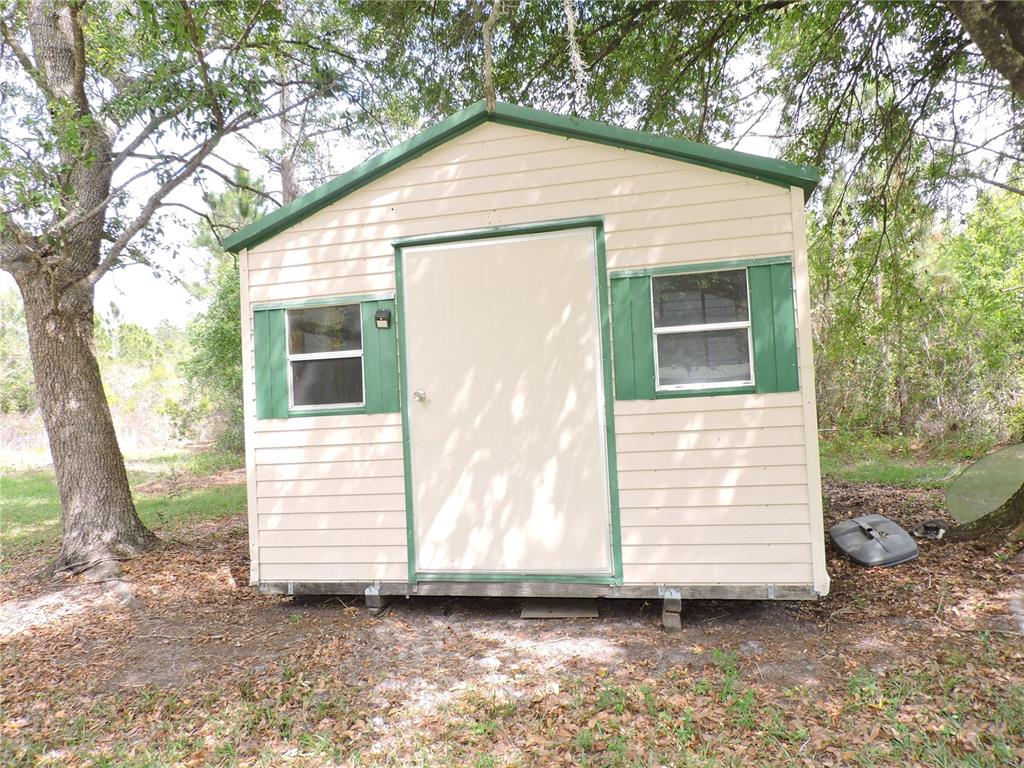 294 Tiger Lake Road Lake Wales, FL 33898 - Photo 47 of 56 a view of a house with a yard