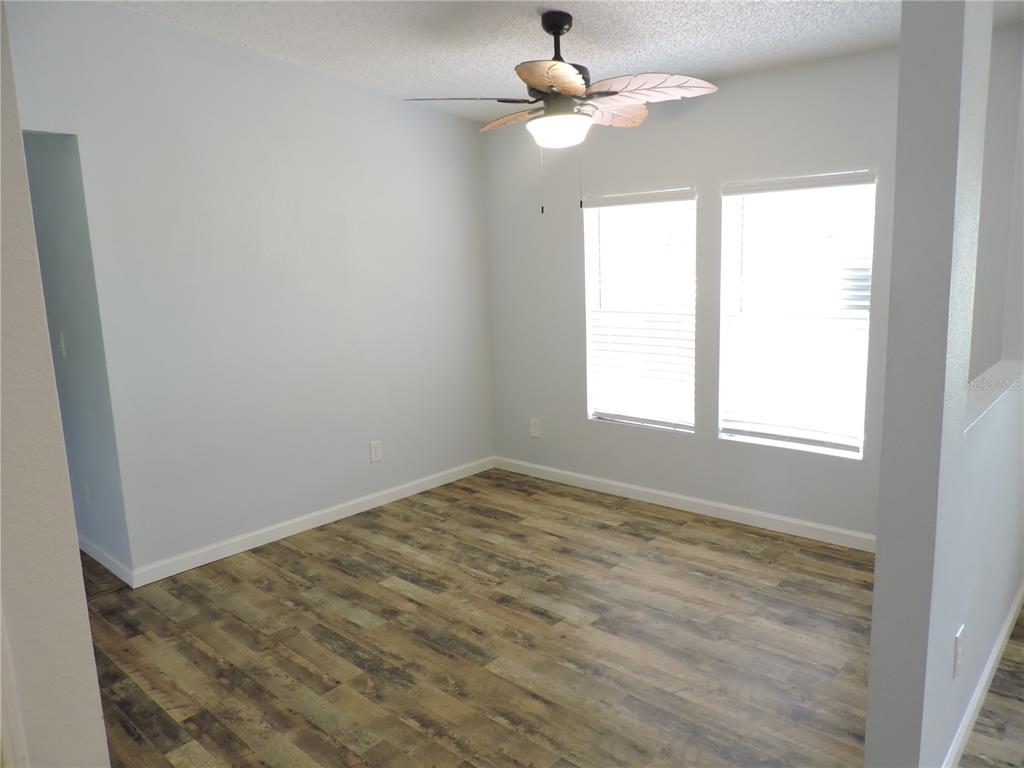 294 Tiger Lake Road Lake Wales, FL 33898 - Photo 8 of 56 an empty room with a window and a fan